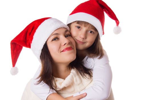 Happy mother and daughter hugging in Christmas hats over white