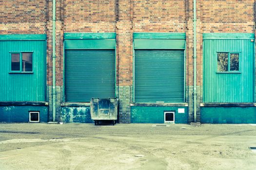 Blue doors and windows at the back of a factory