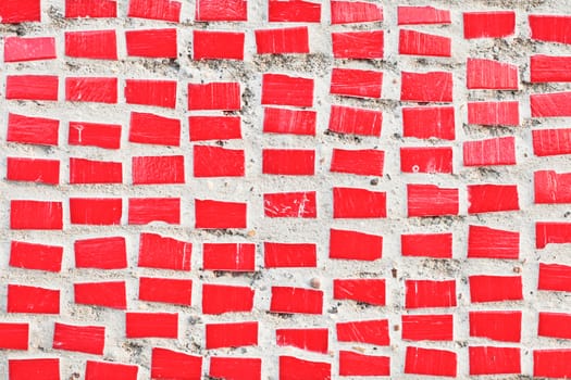 Small red tiles on a stone surface as a background