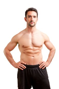 Fit man standing shirtless with his arms at his waist in a white background
