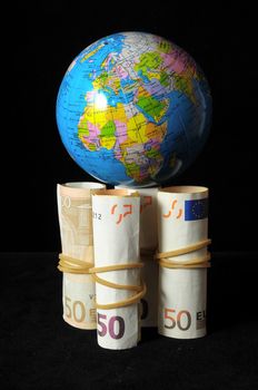 The Planet Earth and Rolled Money Financial Concept