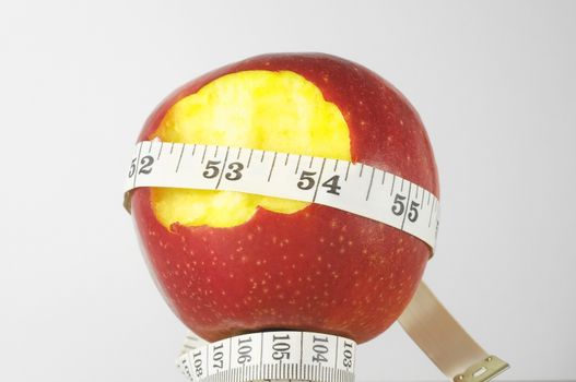 Diet Apple and Meter on a White Background 