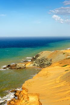 View of a dry desert coastline and the Caribbean Sea with various shades of blue near Cabo de la Vela in La Guajira, Colombia