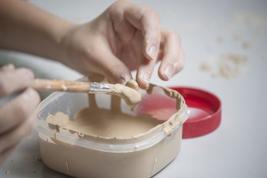 Girl make toyfrom clay. High resolution image.