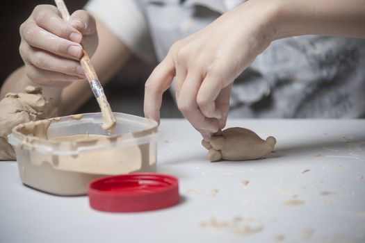 Girl make toyfrom clay. High resolution image.