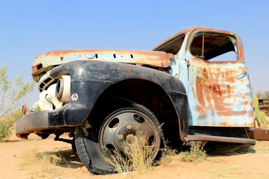 Old and rusty car wreck at the last gaz station before the Namib desert. Solitaire, Namibia.