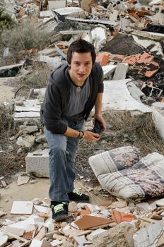 Young gamer with a console in desolate surroundings