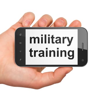 Education concept: hand holding smartphone with word Military Training on display. Generic mobile smart phone in hand on White background.