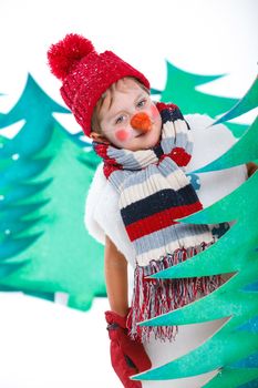 Cute little boy in suit snowman in red hat and mittens