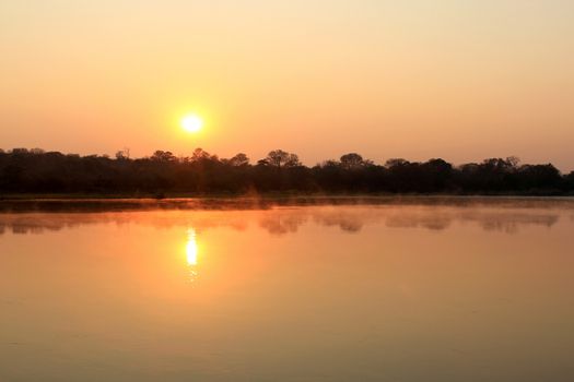 Sunrise at Kavango river whit mist on the water surface, Caprivi region. Namibia