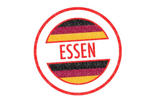 Passport-style ESSEN rubber stamp over a white background.