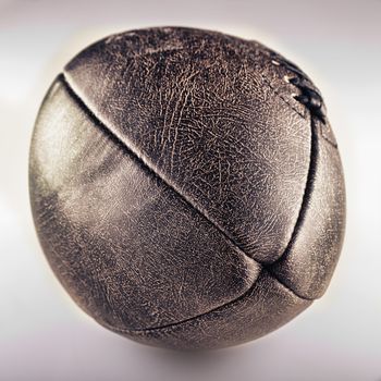 Old football in closeup over a dirty white background