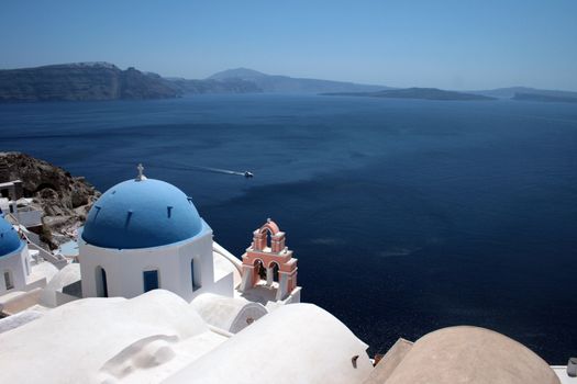 Famous greek island church over aegean mediterranean sea santorini greece with cruise ship in distance