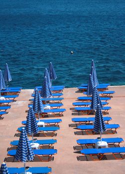 Chairs and umbrellas next to the sea.