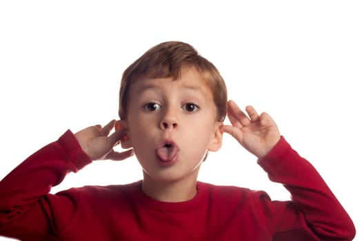 Little blond boy making funny faces.