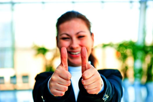 Girl in a business suit shows that everything is fine