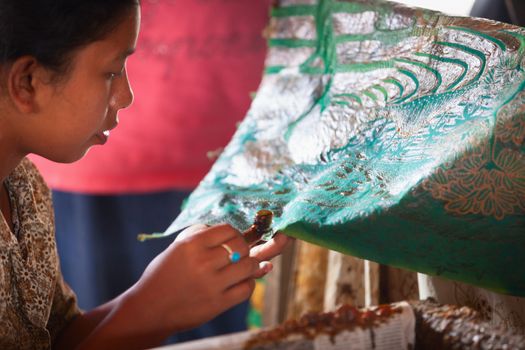 BALI, INDONESIA - Sep 21: Balinese woman applies wax on a piece of batik, on Sep 21, 2012 in Bali, Indonesia. Batik-making is an important part of Indonesian culture. 