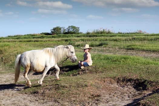 little girl with cowboy hat and pony horse 