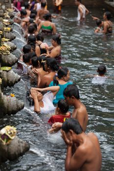 TIRTA EMPUL, INDONESIA - SEP 21: Bali prayers take a bath  in the sacred holy spring water on Sep 21, 2012 in Tirta Empul, Bali, Indonesia. It is famous place for purification of Bali people