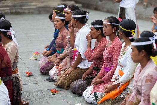 TAMPAK SIRING, BALI, INDONESIA - SEP 21: People praying at holy spring water temple Puru Tirtha Empul during the religious ceremony on Sep 21, 2012 in Tampak Siring, Bali, Indonesia