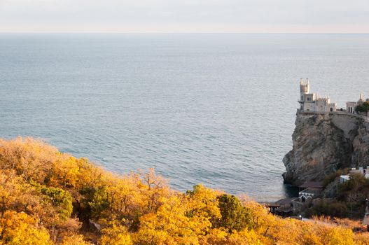 Swallow's Nest, crimea, Ukraine with autumnal trees on front