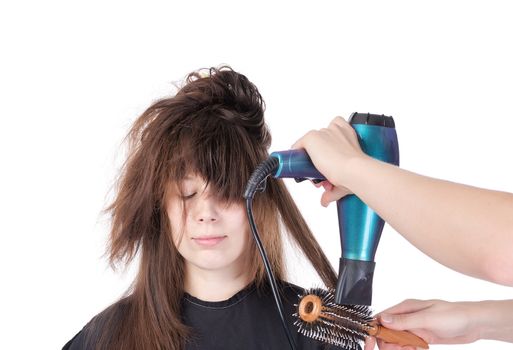 Woman enjoying having her hair blow dried, isolated on white