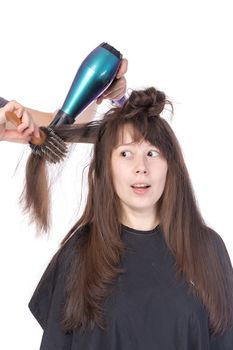 Woman enjoying having her hair blow dried, isolated on white