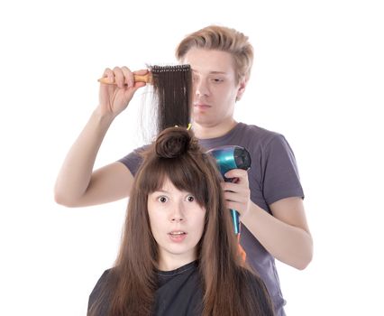 Woman enjoying having her hair blow dried, isolated on white