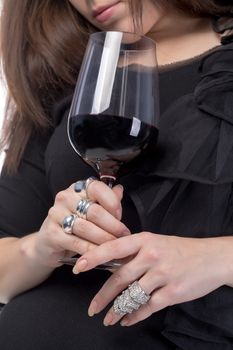 Young woman with red wine from a glass, closeup