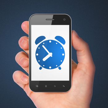 Timeline concept: hand holding smartphone with Alarm Clock on display. Generic mobile smart phone in hand on Dark Blue background.