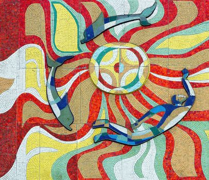 decorative tile mosaic on the wall - dolphin, sun and diver