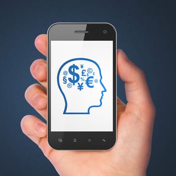 Education concept: hand holding smartphone with Head With Finance Symbol on display. Mobile smart phone in hand on Blue background.