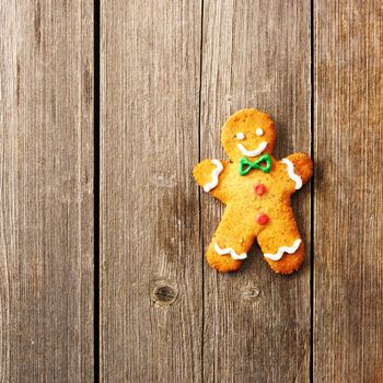 Christmas homemade gingerbread man over wooden table