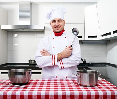 Male chef at kitchen getting ready to cook