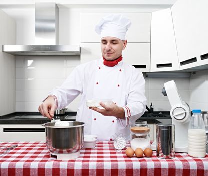 Male chef at kitchen getting ready to cook