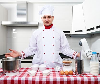 Male chef at kitchen getting ready to cook