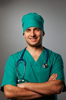 Surgeon with stethoscope over grey background