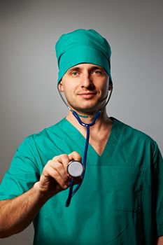 Surgeon with stethoscope over grey background