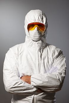 Scientist in protective wear, glasses and respirator 