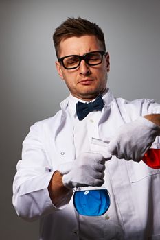 Crazy scientist against grey background