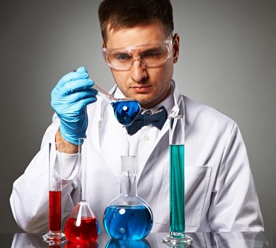 Scientist in protective glasses at laboratory