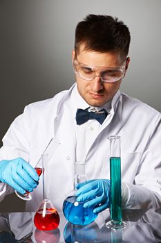 Scientist in protective glasses at laboratory