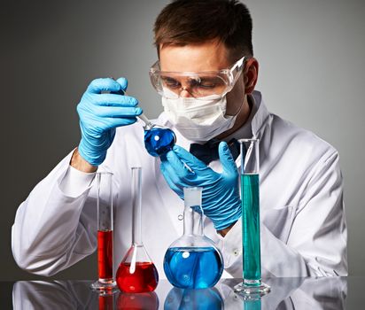 Scientist in protective glasses at laboratory