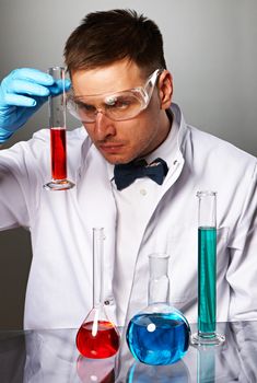 Scientist in protective glasses at laboratory