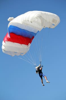 parachutist flying on blue sky