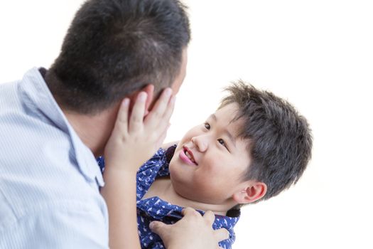 A child holding to his daddy face showing affection on a isolated white background.