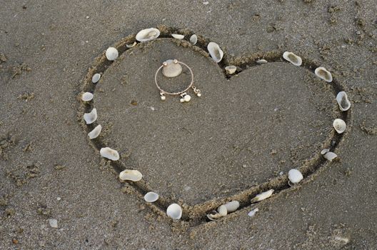 drawing heart on the sand in the beach