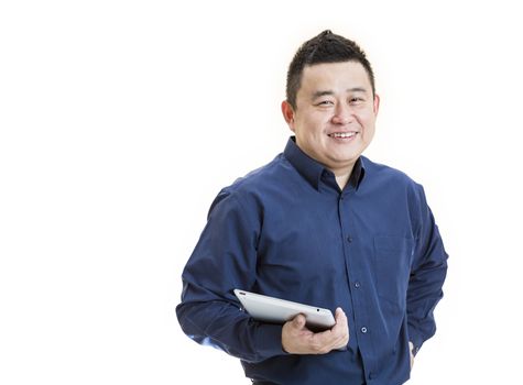 A positive Asian male office worker front view holding tablet on isolated white background.