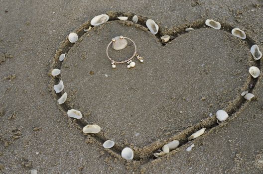 drawing heart on the sand in the beach