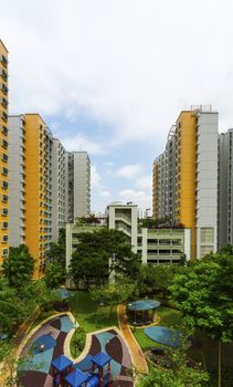 A new colorful neighborhood estate with car park and playground.